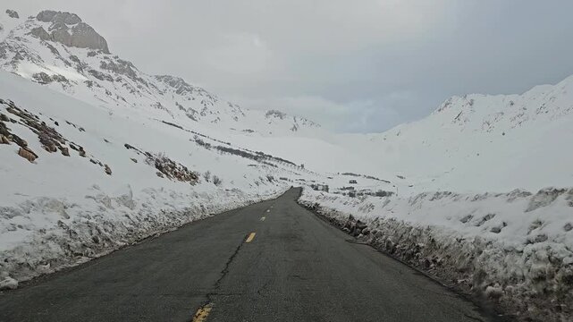 Snow-covered mountain road winding through rugged snowy peaks and a remote winter landscape under a cold, overcast sky.
📍Hawraman Takht, Kurdistan 
