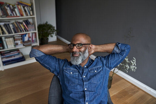 Mature man sitting relaxed at home