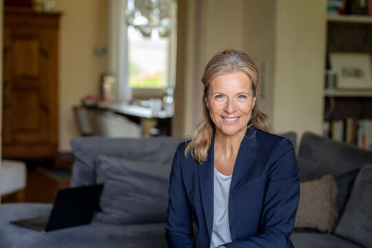 Portrait of smiling mature businesswoman at home
