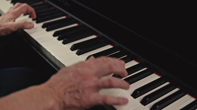 Grand piano playing in studio setting elderly individual skillfully 
