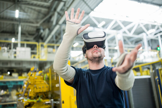 Man wearing VR glasses in modern factory
