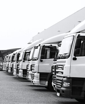 lorries parked up outside a company's car parking area no people stock photo