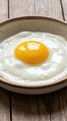 Bright yellow yolk fried egg glossy white cooked whites