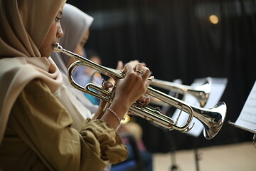 Close-up Trumpet Player Practicing in a Music Rehearsal Room © maha