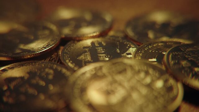 Golden bitcoin coins falling through the air against a dark background, symbolizing cryptocurrency market crash, financial volatility and investment risk