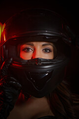 Naklejka na ściany i meble Stylish beautiful young woman in black leather corset and boots posing on vintage motorcycle on old garage dark interior background.