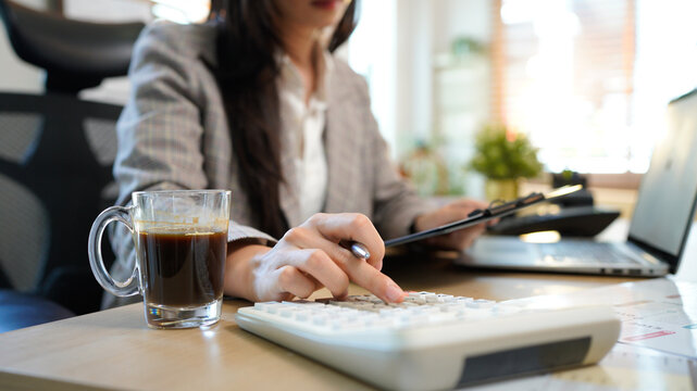 Finance planning, budget or savings manager calculating expenses, taxes or company profits with laptop, paperwork or calculator. female financial leader checking office staff payroll