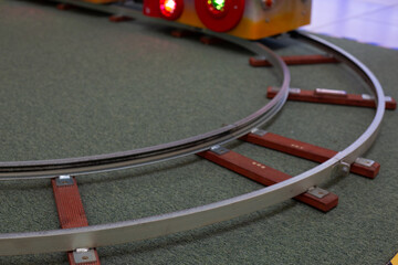 Rotating rails in miniature version. Studying rail transport using a replica of real rails and sleepers. Train as a train driver and track worker. Train simulator on metal rails
