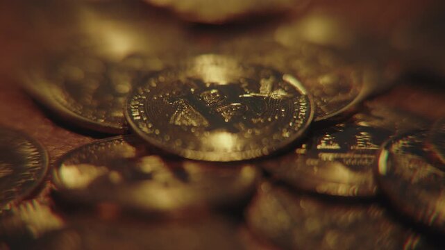 Golden bitcoin coins falling through the air against a dark background, symbolizing cryptocurrency market crash, financial volatility and investment risk