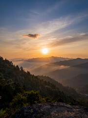 Obraz premium Sunrise Over Misty Mountains With Layered Ridges And A Golden Sky, Serene Nature Landscape