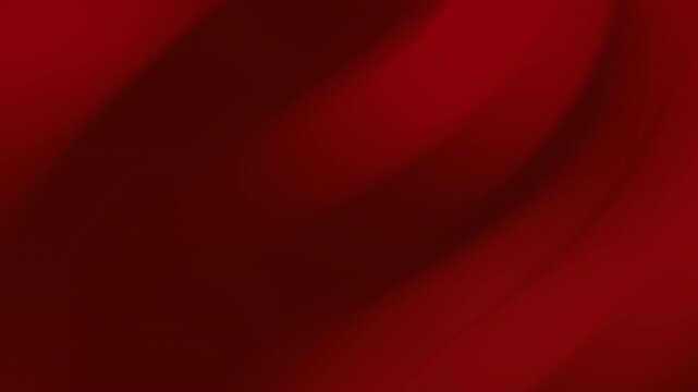 A close-up view of a red fabric texture with smooth folds and soft creases