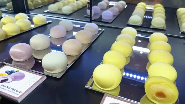 Vietnamese mochi desserts with vibrant yellow caramel creme brulee filling, sweet sticky rice balls offering a delicious taste of da nang street food culture