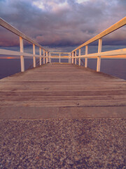 Fototapeta premium wooden pier on the sea at sunset