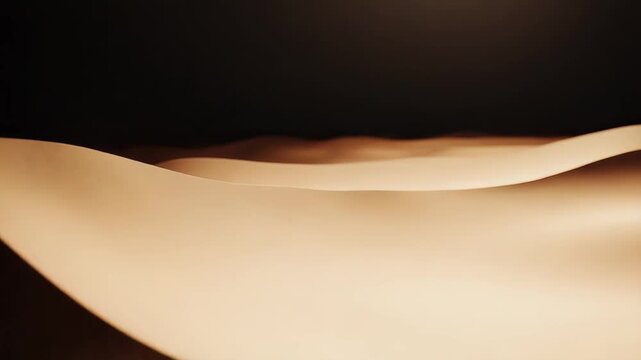Desert sand dunes reflecting an abstract golden light at dusk, creating a tranquil and minimal natural landscape pattern with soft shadows and smooth curves