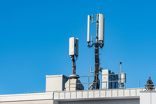 Cellular antennas on a building against blue sky