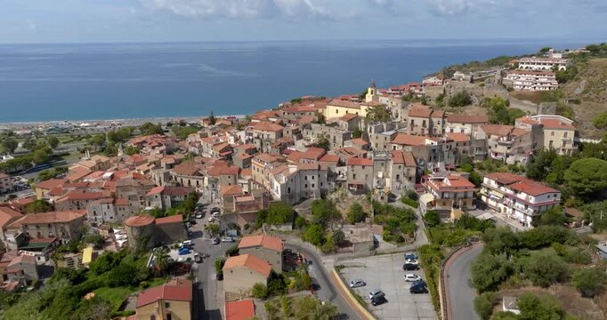 Aerial view of a historic Italian village and its seafront on the horizon. Panorama of Scalea, a town in the province of Cosenza, in Calabria, Southern Italy. It's perched overlooking the sea.