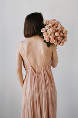 Woman in Pink Dress Holding Rose Bouquet