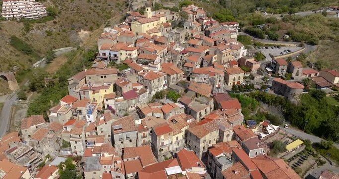 Aerial view of a densely packed historic village, characterized by narrow stone alleys and traditional Mediterranean architecture. It's the historic center of Scalea, in Calabria, Italy.