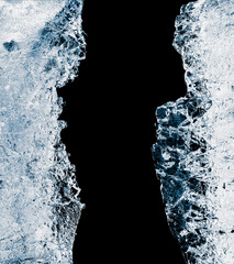 Hole, broken in a pure transparent crushed ice with cracks on a black background, close-up.