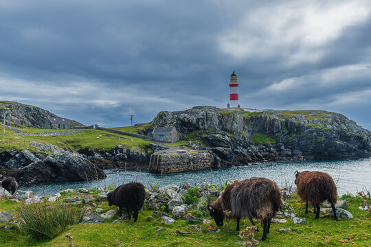 the red and white Eilean Glas Lighthouse on the east coast of the island of Scalpay in the Outer Hebrides, Scotland, UK