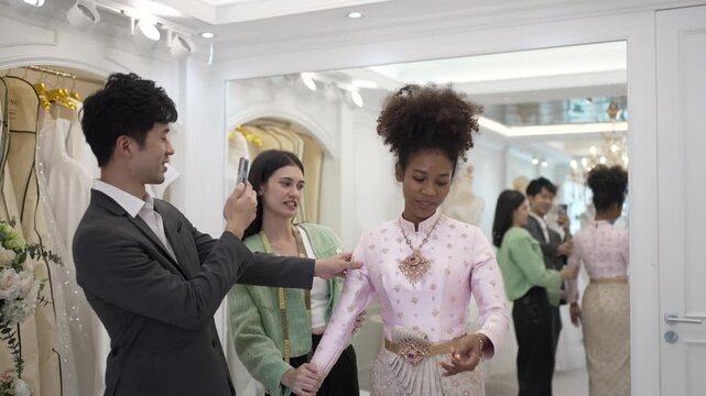 The couple is choosing dress for wedding event at wedding studio. Lifestyle, wedding event.