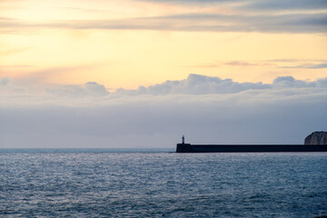 Newhaven harbour jetty and lighthouse on a cloudy winter day, East sussex, England
