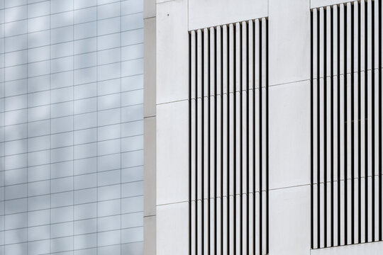 Minimal white modern architecture building facade with windows and clean lines forming abstract pattern for contemporary design background