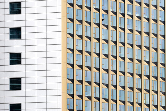 Abstract modern architecture building facade with windows in grid pattern showing geometric contrast and repetitive urban design texture