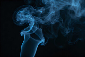 Obraz premium Abstract blue smoke on black background: A wispy plume of azure smoke elegantly curls and twists, creating an abstract display against the deep black backdrop. The scene evokes a sense of mystery.