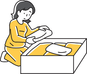 箱に衣類を入れている女性