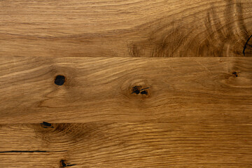 Fototapeta premium Close-up texture of natural oak wood surface with knots and cracks, rustic wooden background.