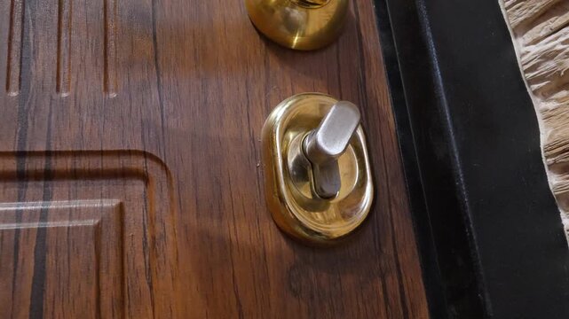 Close-up of the front door lock mechanism that automatically actuates with the deadbolt extended to close the entrance, showing the state-of-the-art home security system in action