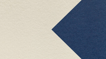 Textured light beige paper background with dark blue arrow, macro. Template with copy space for...