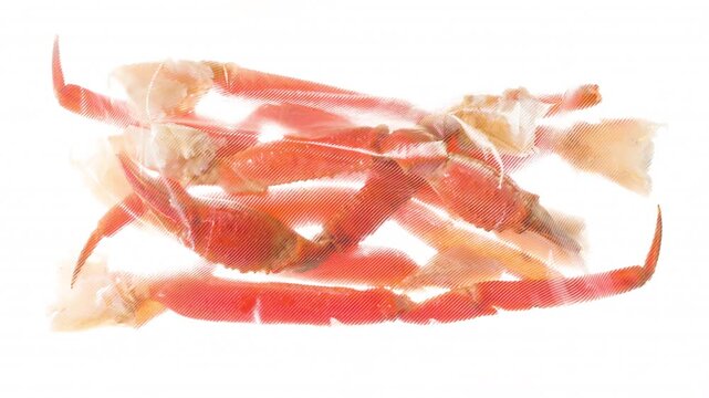 Packing and Freezing Fresh Crab Claws. Crab claws are vacuum packed and rapidly cooled by an ice jet, creating the effect of white steam on a white background