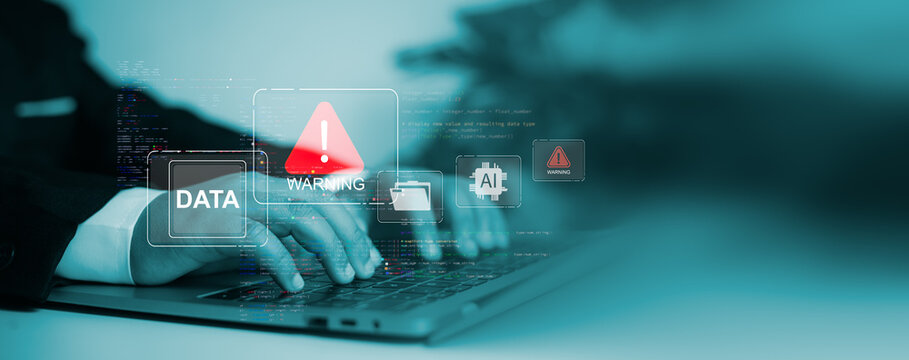 Hands typing on a laptop with digital warning icons and AI symbols, highlighting cybersecurity threats, data breaches, system vulnerability, and information protection technology.