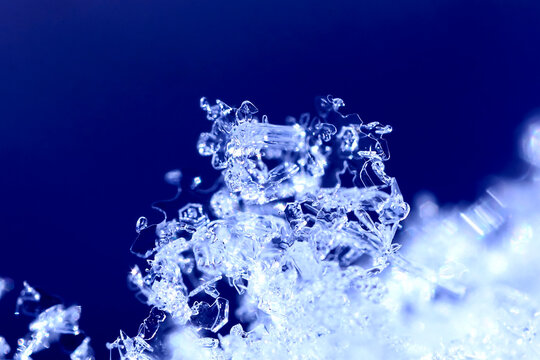 Macro of delicate snow crystals and frost outdoors in winter in Germany
