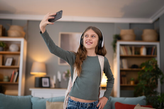 Teenage girl making video call holding smartphone