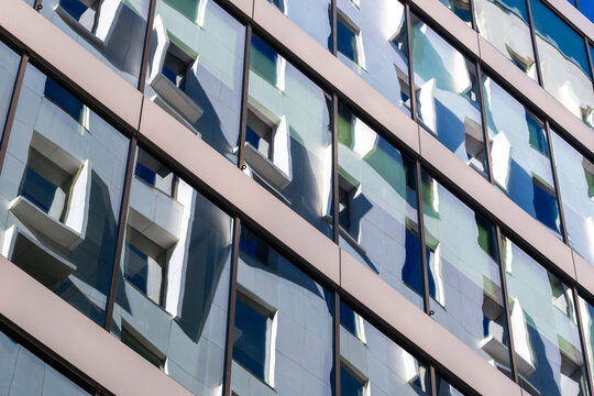Modern urban office architecture with facade windows grid pattern and daylight perspective designed as an abstract background texture