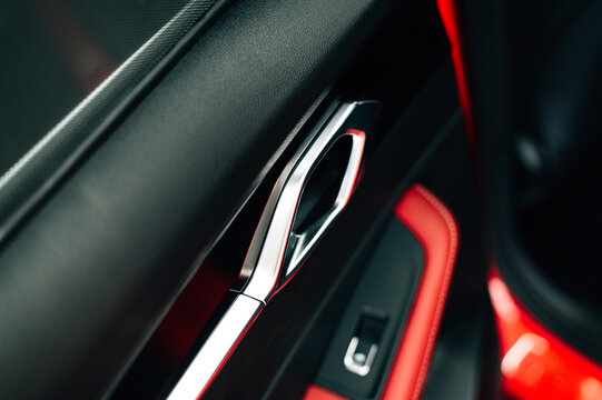 Interior car door handle close-up, modern vehicle detail showing clean design and transportation concept.