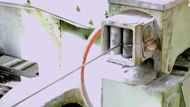 Metal Wire Drawing Process in Industrial Machinery with Lubricant Dust