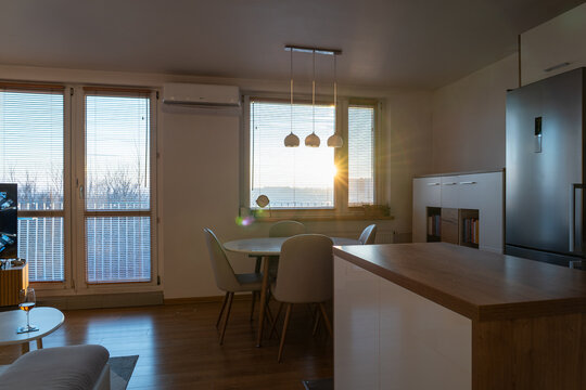 Modern apartment living room interior at sunset
