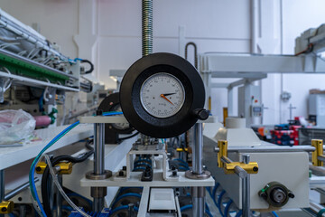Pressure gauge monitoring industrial machinery in a modern factory