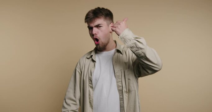 Exciting expressive journey of a young man showcasing emotions through gestures in a warm-toned setting