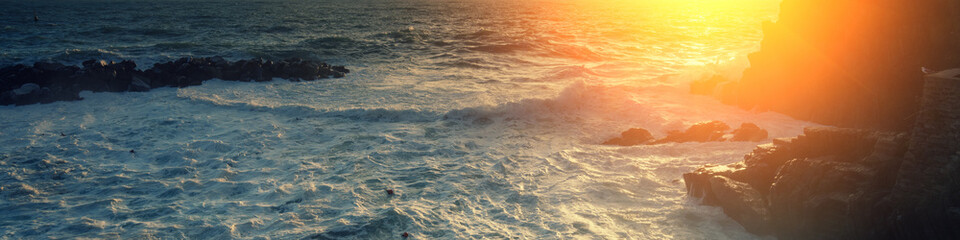 Sunset over rocky sea coast