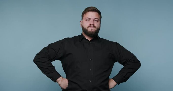 Man expressing confidence and determination in a blue background setting through dynamic gestures and facial expressions