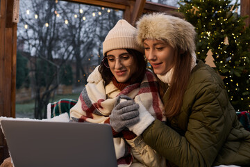 Fototapeta premium Loving couple warms up together while enjoying cozy winter moments indoors