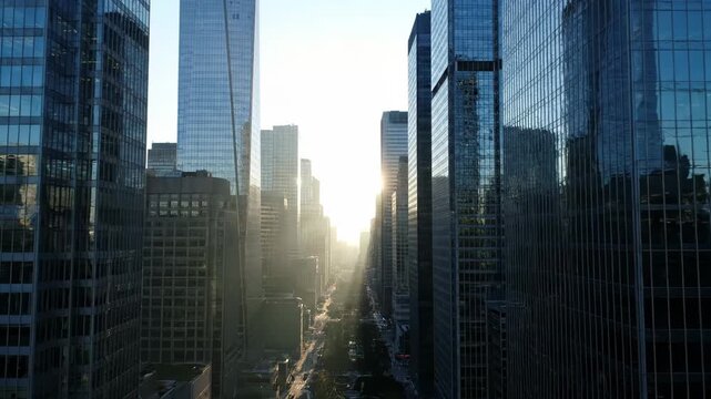 Aerial view major metropolitan city street canyon lined with modern glass skyscrapers sunrise, for ambition, corporate power, global finance, relentless pursuit urban success