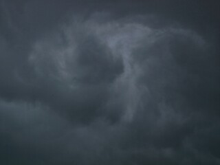 Obraz premium Dark dramatic storm clouds and approaching rain. Creating a moody and dramatic atmosphere