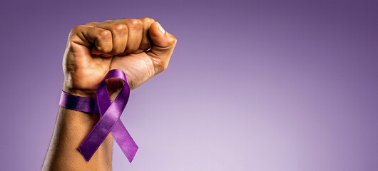 Raised purple fist of a woman for international women's day and the feminist movement