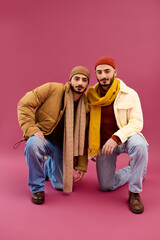 Obraz premium Stylish twin brothers posing together with confidence in a vibrant setting